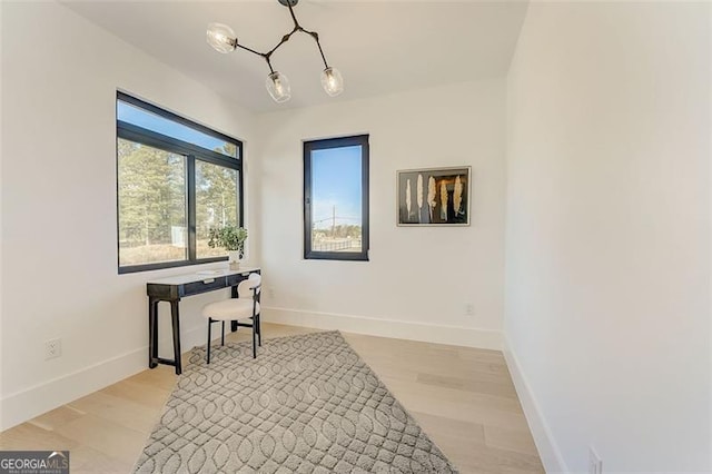 office area with light wood-style flooring and baseboards