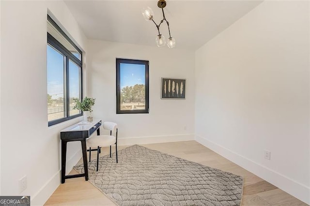 office featuring baseboards and light wood-style flooring