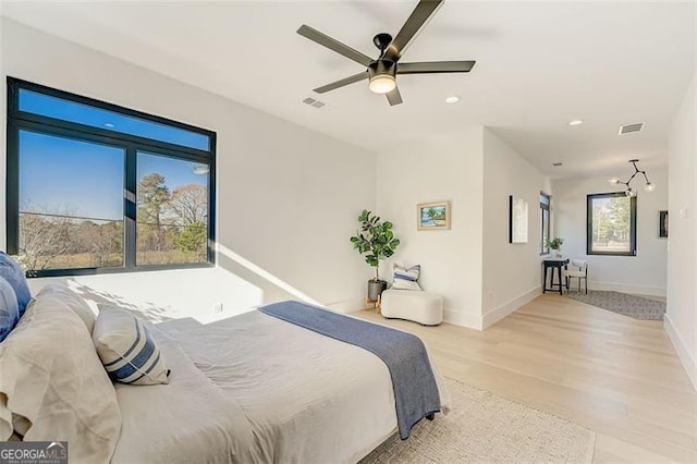 bedroom with recessed lighting, visible vents, baseboards, and light wood-style floors