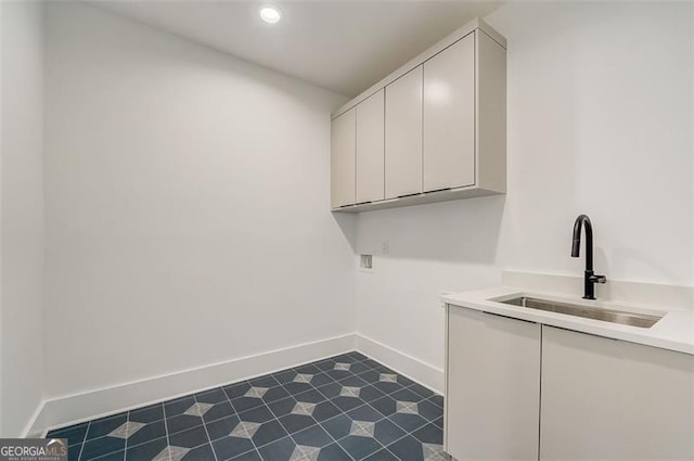 laundry room featuring a sink, recessed lighting, cabinet space, baseboards, and hookup for a washing machine