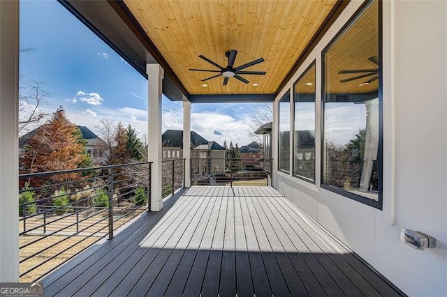 wooden deck featuring ceiling fan