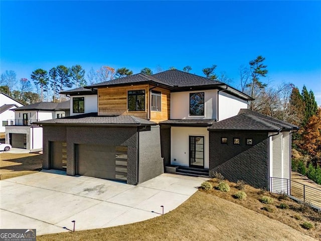 view of front facade with stucco siding, driveway, and a garage