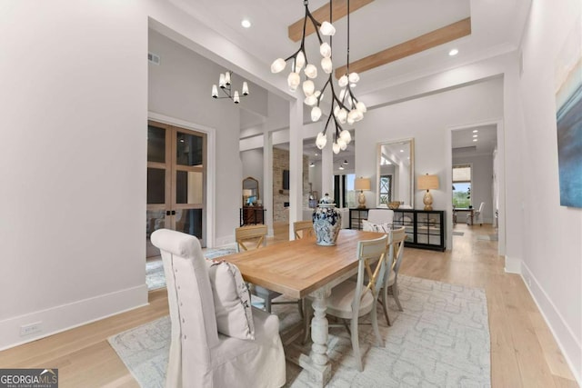 dining room featuring recessed lighting, a notable chandelier, baseboards, and light wood-type flooring