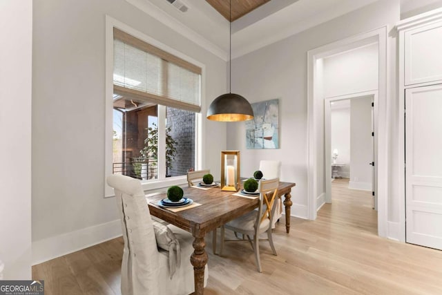 dining area featuring visible vents, baseboards, and light wood-type flooring