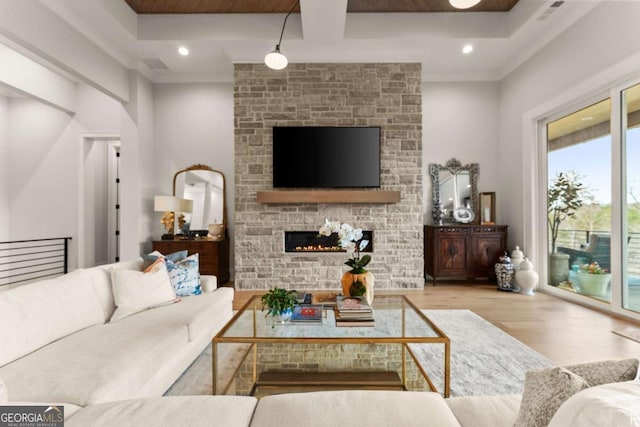 living area featuring recessed lighting, visible vents, wood finished floors, and a fireplace