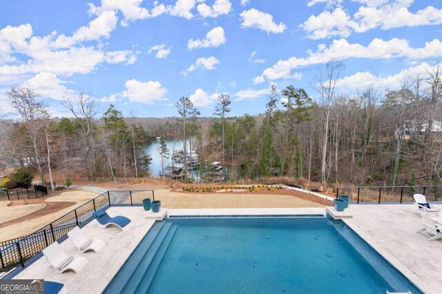 view of pool featuring fence, a fenced in pool, and a water view
