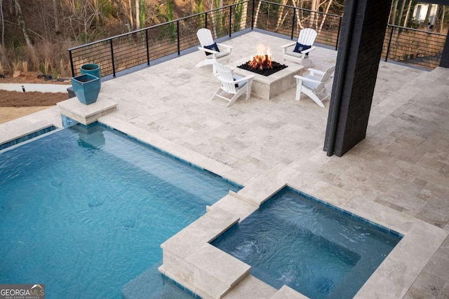 view of pool with a fenced in pool, an in ground hot tub, an outdoor fire pit, and a patio