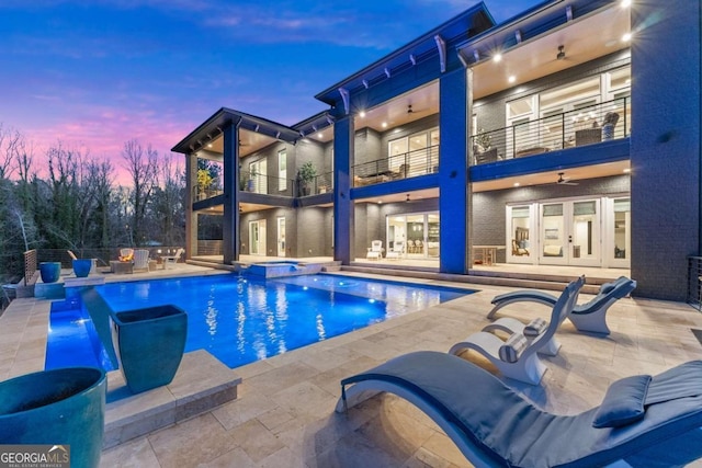 view of swimming pool with french doors, a patio, a ceiling fan, and a pool with connected hot tub
