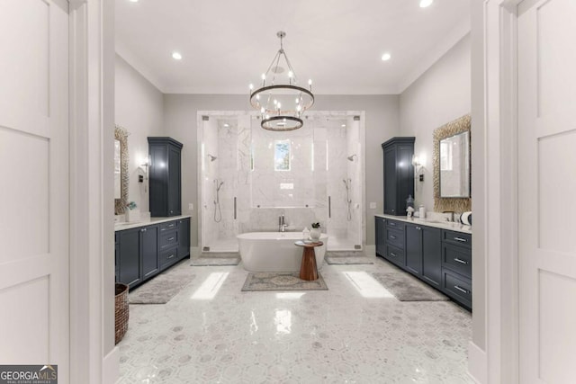 bathroom with two vanities, ornamental molding, an inviting chandelier, a shower stall, and a soaking tub