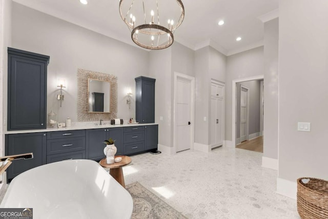 bathroom with recessed lighting, a freestanding tub, a chandelier, and crown molding
