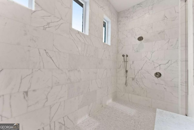 full bath featuring a marble finish shower
