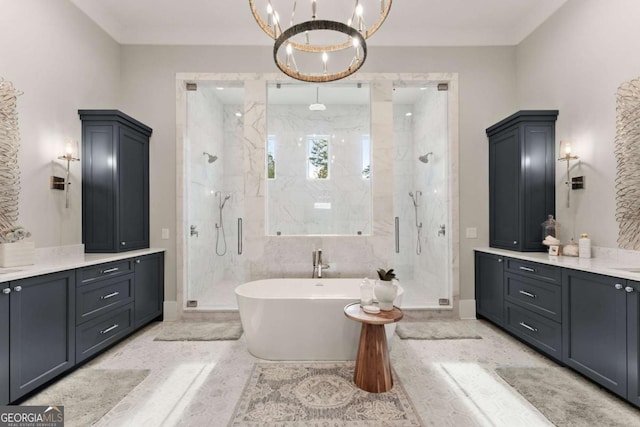 full bath with a marble finish shower, baseboards, an inviting chandelier, a freestanding tub, and vanity