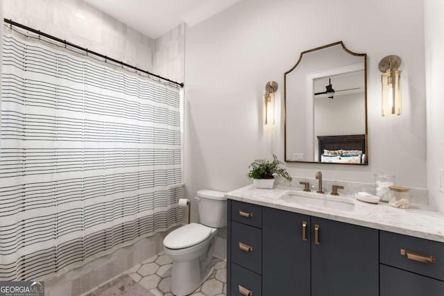 full bathroom featuring toilet, vanity, and a shower with curtain