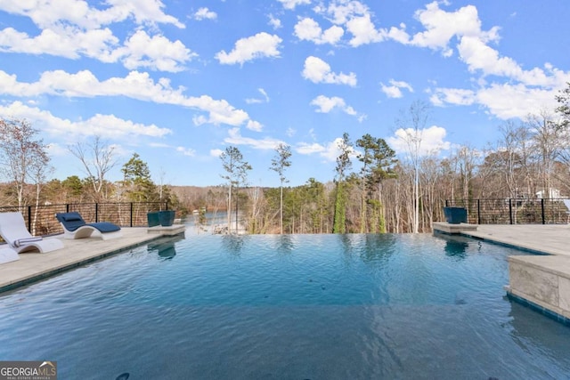 view of pool featuring a patio and an infinity pool