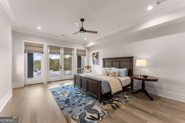 bedroom with wood finished floors, access to outside, french doors, and baseboards