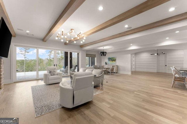living area with light wood-type flooring, beamed ceiling, an inviting chandelier, and recessed lighting