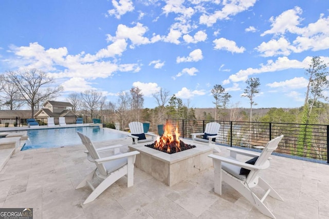 view of patio / terrace with a fenced in pool and an outdoor fire pit