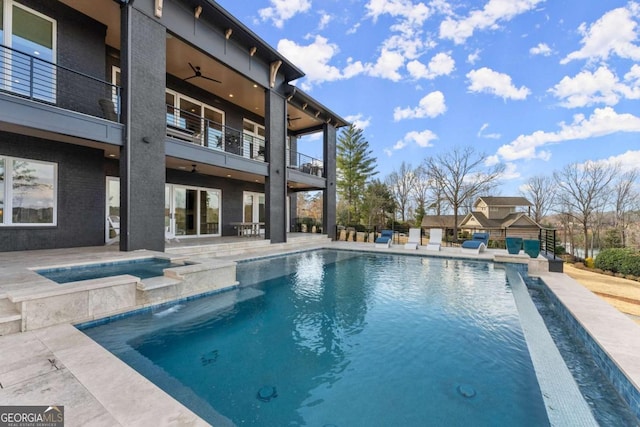 view of pool with a fenced in pool, an in ground hot tub, a ceiling fan, and a patio