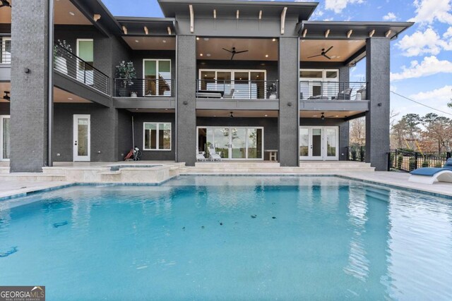 view of swimming pool featuring french doors, a patio, an in ground hot tub, and a ceiling fan