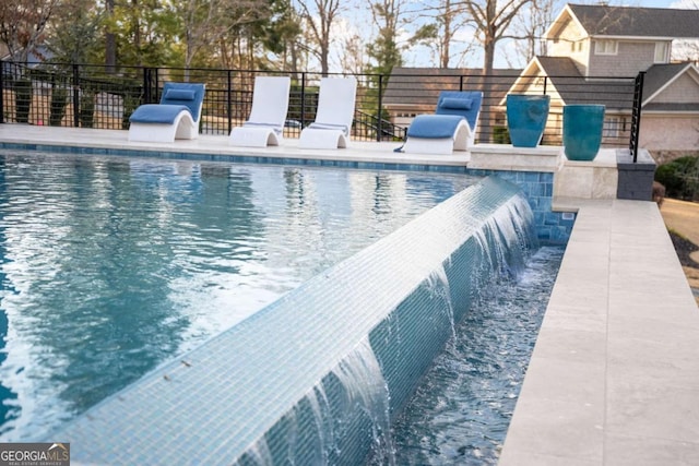 view of pool with a fenced in pool and fence