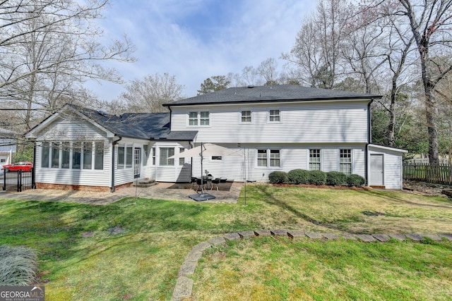 back of house with a patio area, a lawn, fence, and roof with shingles