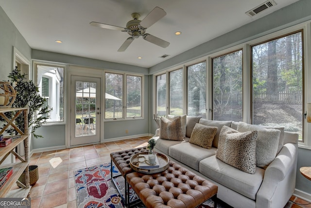 sunroom with visible vents, a healthy amount of sunlight, and a ceiling fan