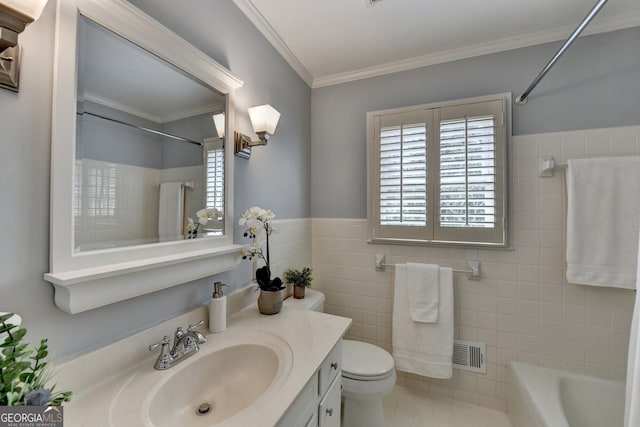 bathroom with vanity, visible vents, crown molding, tile walls, and toilet