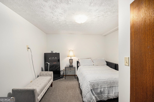 bedroom featuring carpet and a textured ceiling