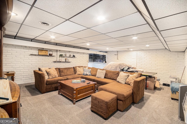 carpeted living area featuring recessed lighting, a paneled ceiling, visible vents, and brick wall