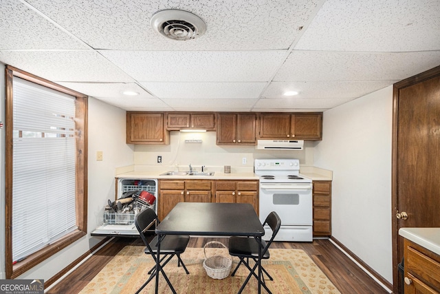 kitchen with ventilation hood, dark wood-style floors, visible vents, white electric stove, and a sink