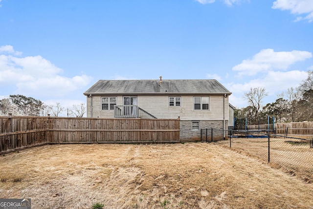 back of property with a fenced backyard