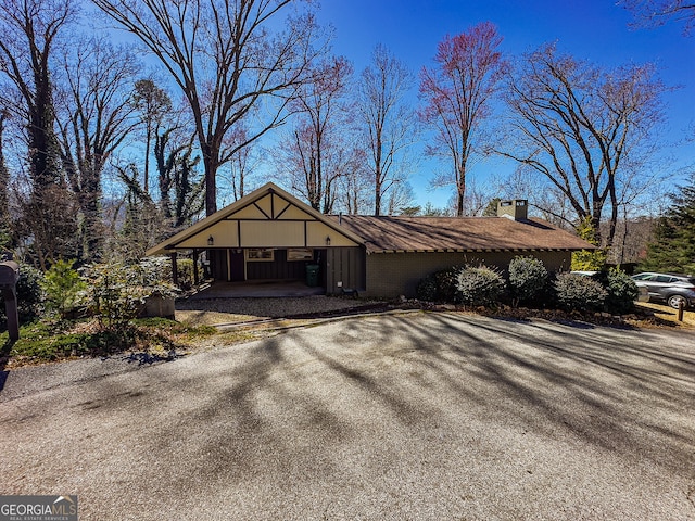 view of outbuilding with a carport and driveway