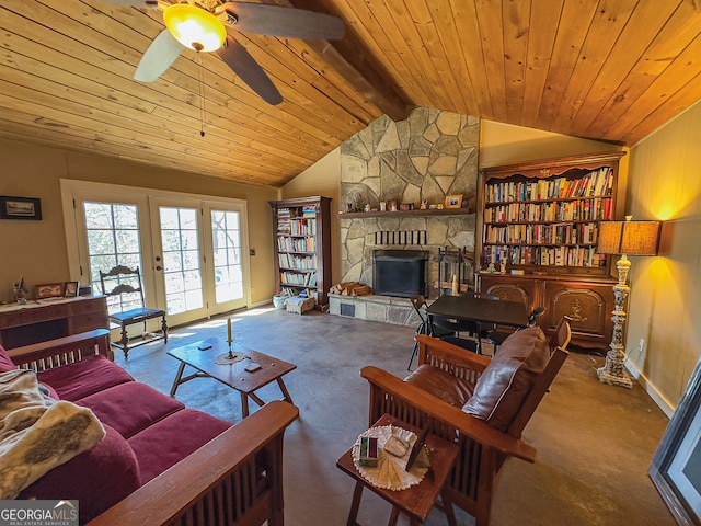 living room featuring lofted ceiling with beams, wood ceiling, a stone fireplace, and a ceiling fan