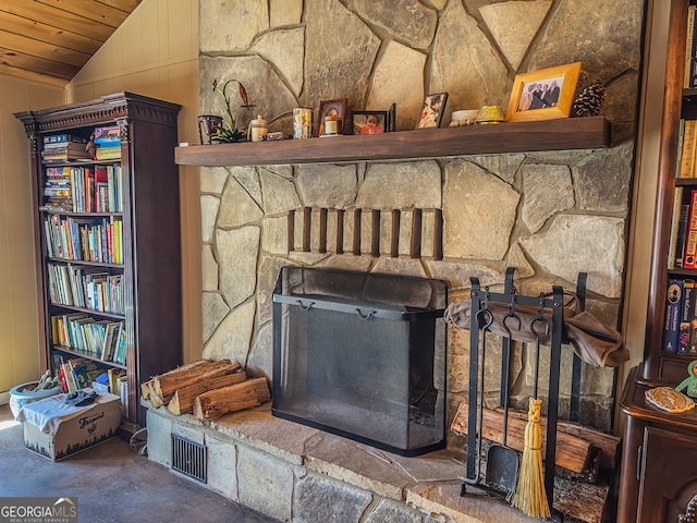 room details with a stone fireplace and concrete floors