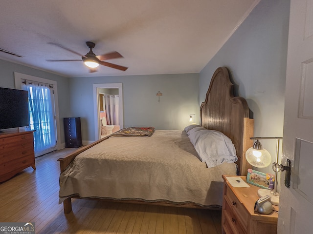 bedroom with access to outside, visible vents, ceiling fan, and hardwood / wood-style floors