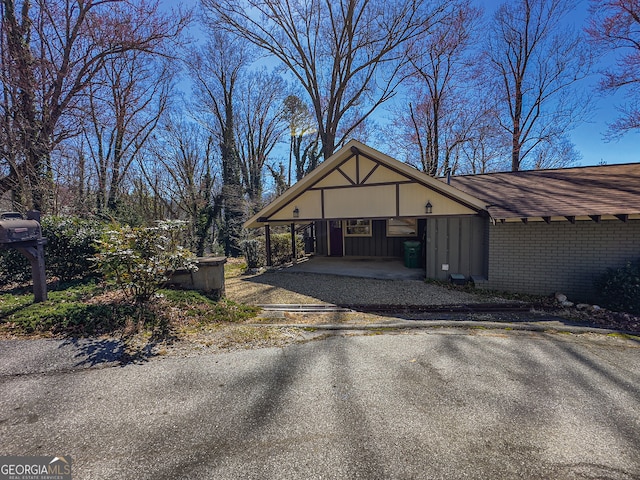 garage with a carport and driveway