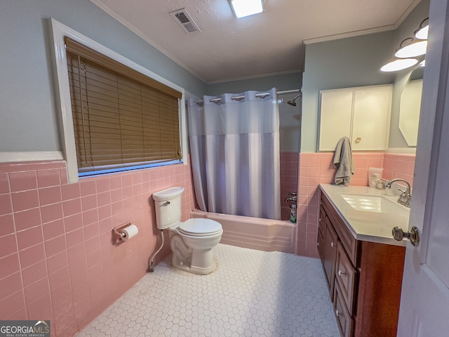 bathroom featuring vanity, visible vents, ornamental molding, tile walls, and toilet