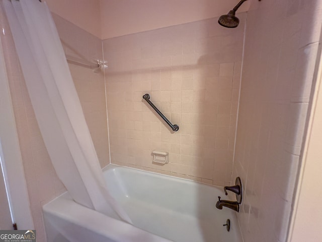 bathroom with shower / bath combination with curtain