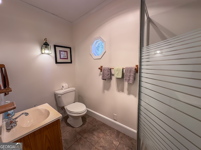 bathroom with toilet, vanity, and baseboards