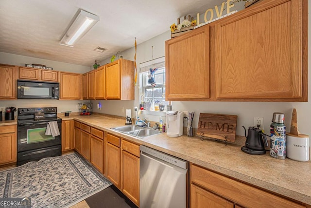 kitchen with visible vents, black appliances, light countertops, and a sink