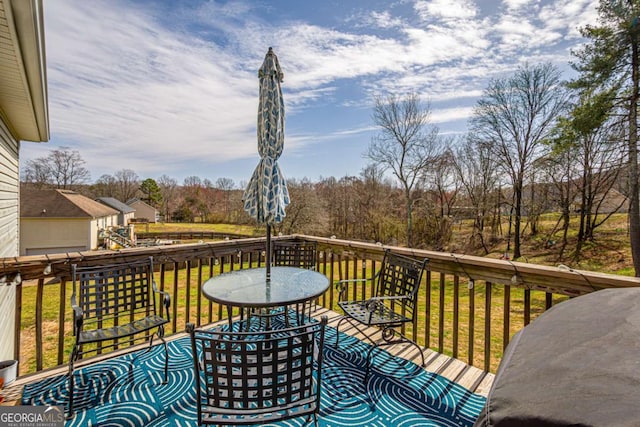 wooden deck featuring a yard