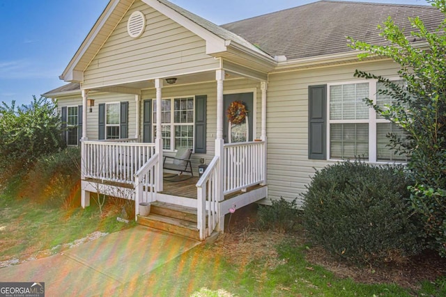 view of front facade featuring a porch and a shingled roof