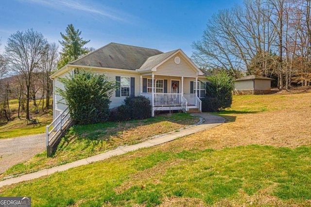 view of front of home with a porch and a front lawn