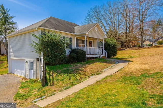 view of property exterior featuring a garage, a yard, covered porch, and aphalt driveway