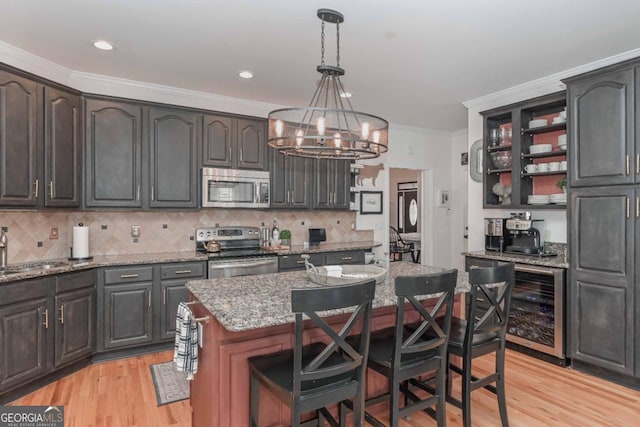 kitchen featuring a chandelier, wine cooler, stainless steel appliances, and open shelves