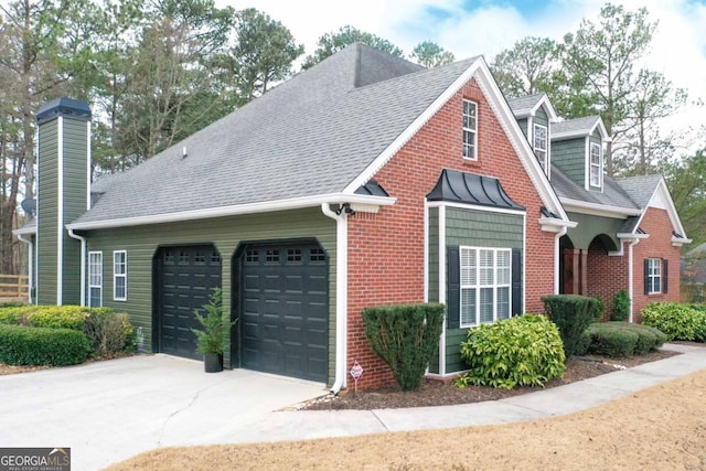 view of home's exterior featuring brick siding, a shingled roof, concrete driveway, a chimney, and a garage