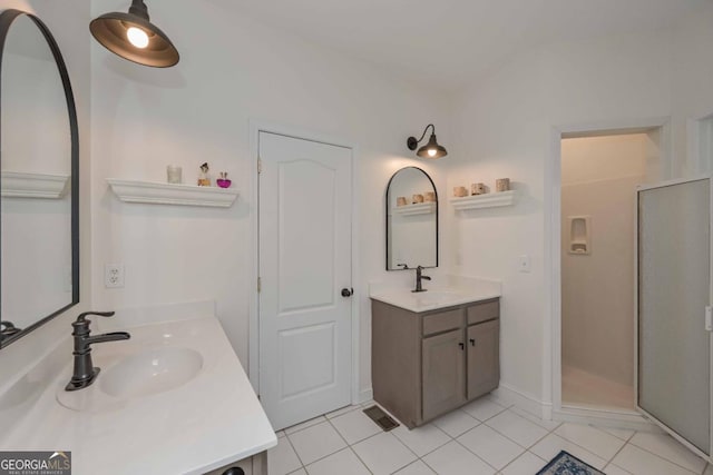 full bath featuring tile patterned flooring, a stall shower, visible vents, and a sink