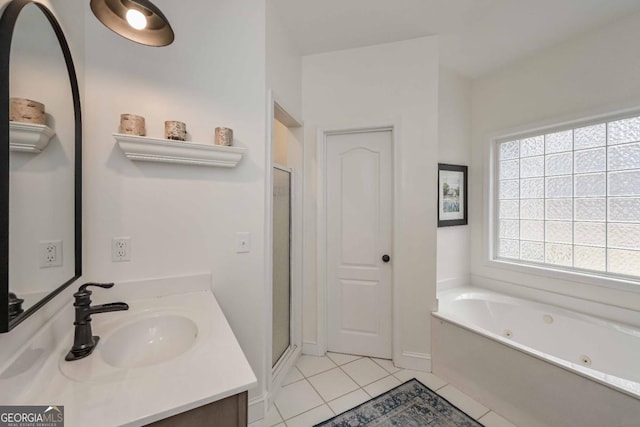 full bathroom with tile patterned flooring, vanity, a tub with jets, and a stall shower