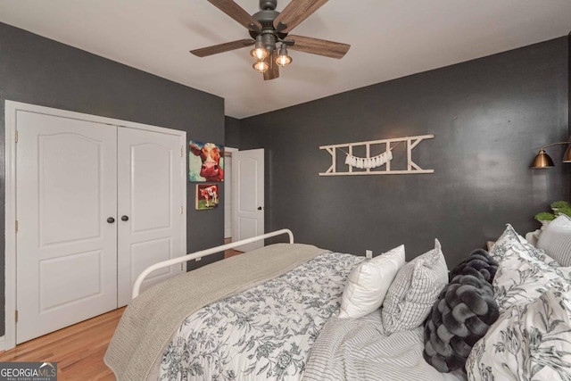 bedroom with a closet, a ceiling fan, and wood finished floors