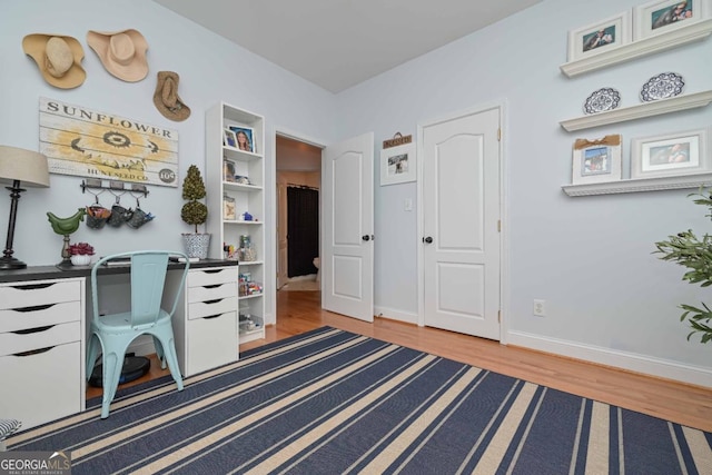 office space with wood finished floors and baseboards